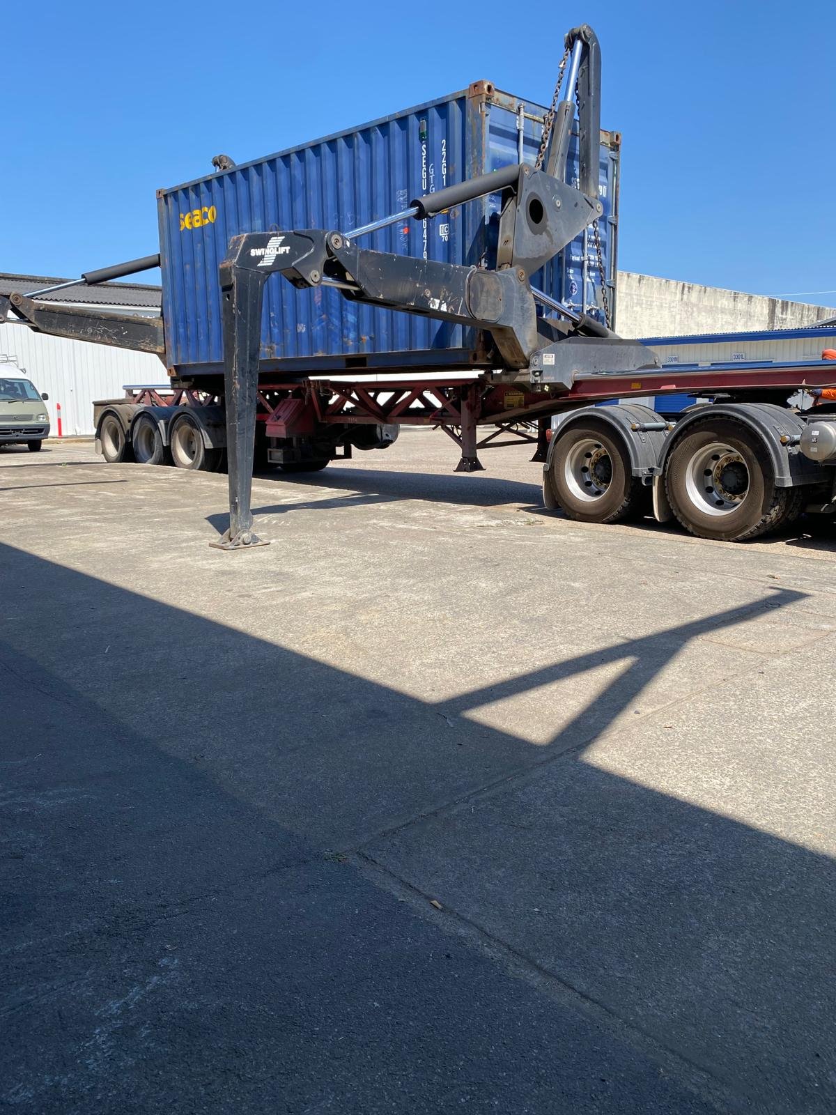 Shipping container being loaded onto a side-lifter truck