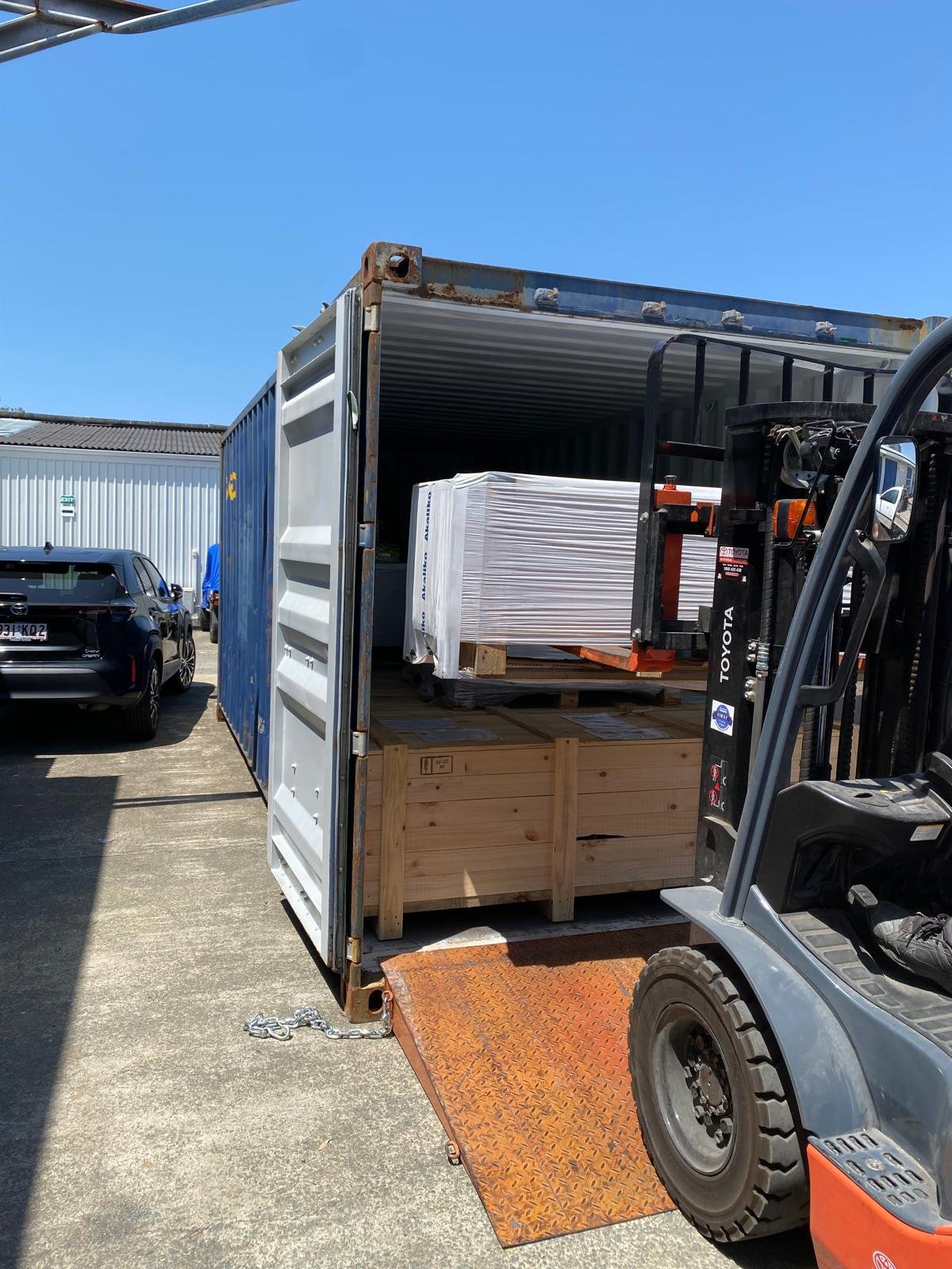 Forklift loading a shipping container